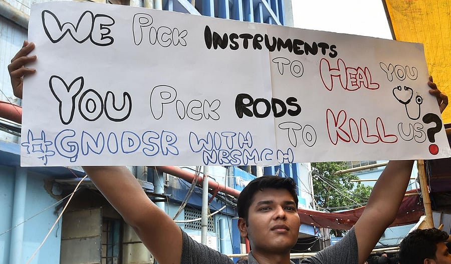 Junior doctors hold placards during a demonstration, in Kolkata (Photo PTI)