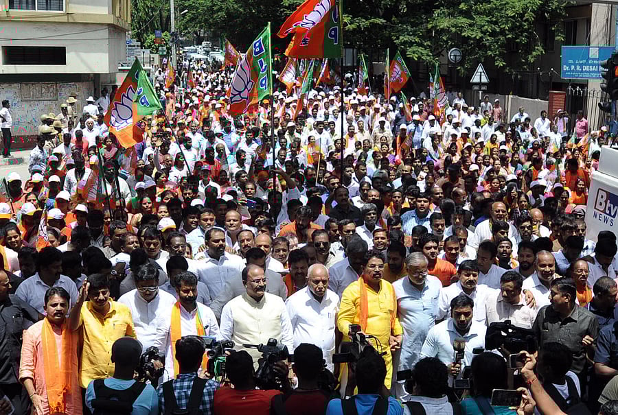 State BJP president Yeddyurappa and other leaders along with party workers take out a rally towards chief minister's home office, opposing the government's decision to transfer land to Jindal Steel, in Bengaluru on Sunday. DH Photo/Pushkar V