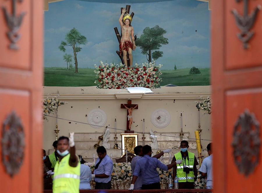 Police officers work at the scene at St. Sebastian Catholic Church, after bomb blasts ripped through churches and luxury hotels on Easter, in Negombo, Sri Lanka April 22, 2019. REUTERS/Athit Perawongmetha