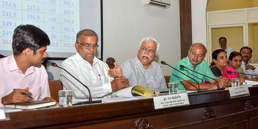 Revenue Minister R V Deshpande addresses officials during a progress review meeting at ZP office in Mysuru on Thursday. Deputy Commissioner Abhiram G Sankar, Higher Education Minister G T Devegowda, Tourism Minister Sa Ra Mahesh and Mayor Pushpalatha Jaga