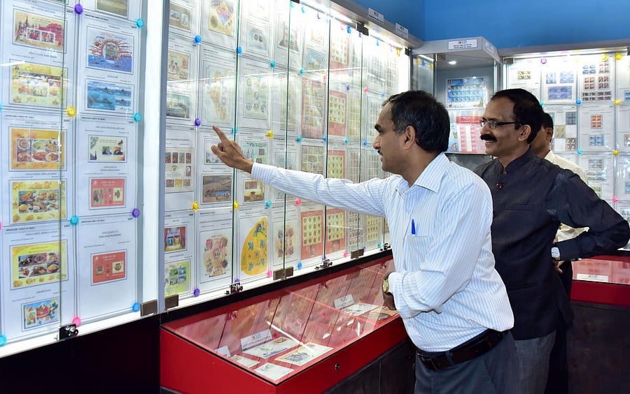 Karnataka Circle Chief Post Master General (CPMG) Dr Charles Lobo and Post Master General, South Kanara Region, S Rajendra Kumar view the exhibits on display at the renovated Mangaluru Philatelic Bureau which was inaugurated at the Head office of departme