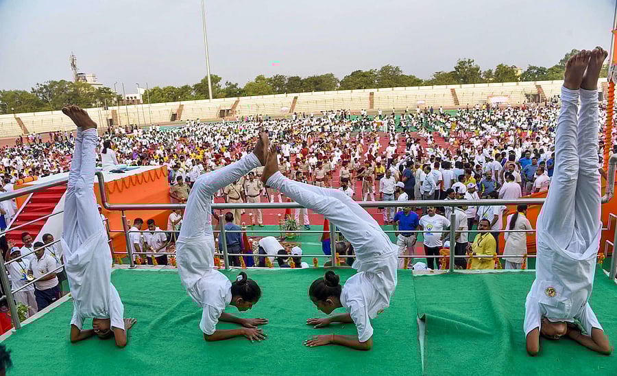 School children perform yoga during an event on the 5th International Day of Yoga at Patliputra Sports Complex in Patna, Friday. (PTI Photo)