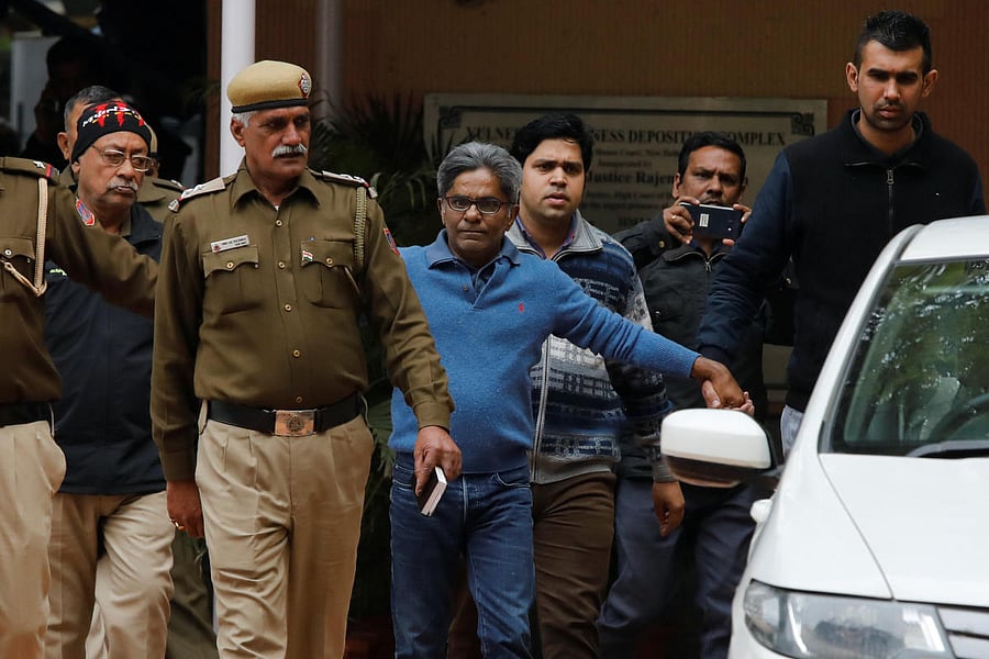 Rajiv Saxena (C), an accused in India's abortive, scandal-tainted helicopter deal with Anglo-Italian firm Agusta Westland, is escorted by police as he leaves a court in New Delhi, India, January 31, 2019. REUTERS/Anushree Fadnavis