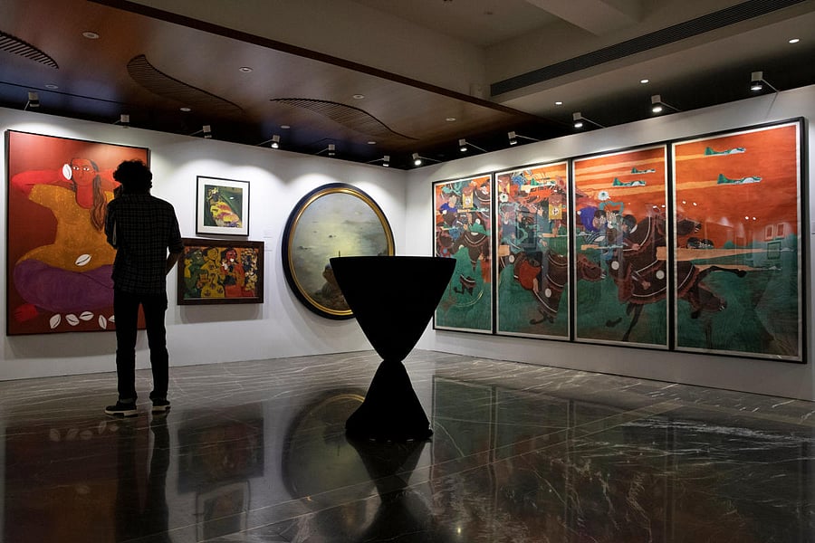 A staff member speaks on his phone as artworks once part of billionaire jeweller Nirav Modi's collection are seen on display ahead of their auction at a gallery in Mumbai, India, March 25, 2019. REUTERS/Danish Siddiqui NO RESALES. NO ARCHIVES