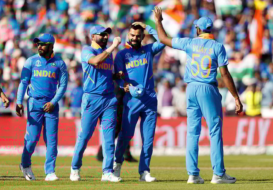India's Virat Kohli celebrates with teammates after the match against West Indies. Photo credit: Reuters
