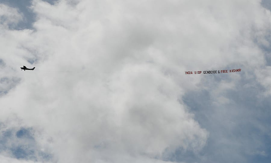 A plane with a banner flies over the match. Reuters