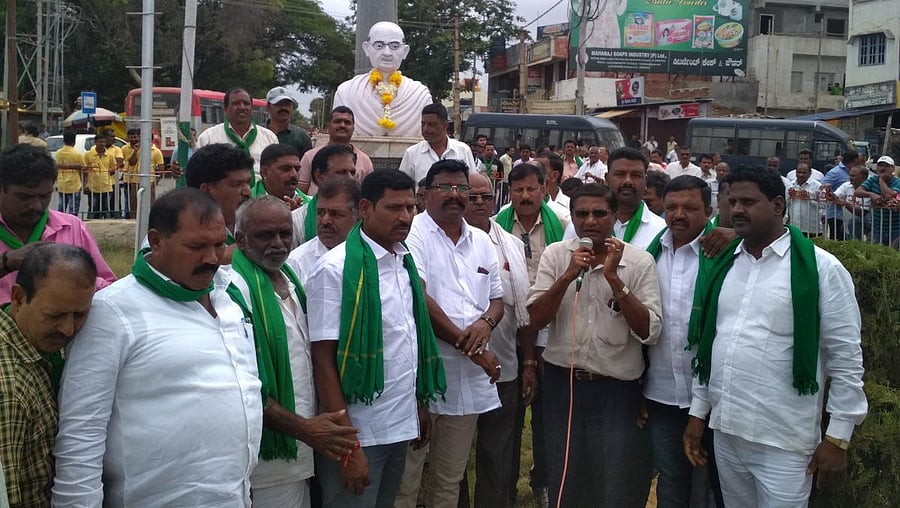 Areca Growers Association President M R Somshekar addresses protesters in front of Mahatma Gandhi Circle in Birur.