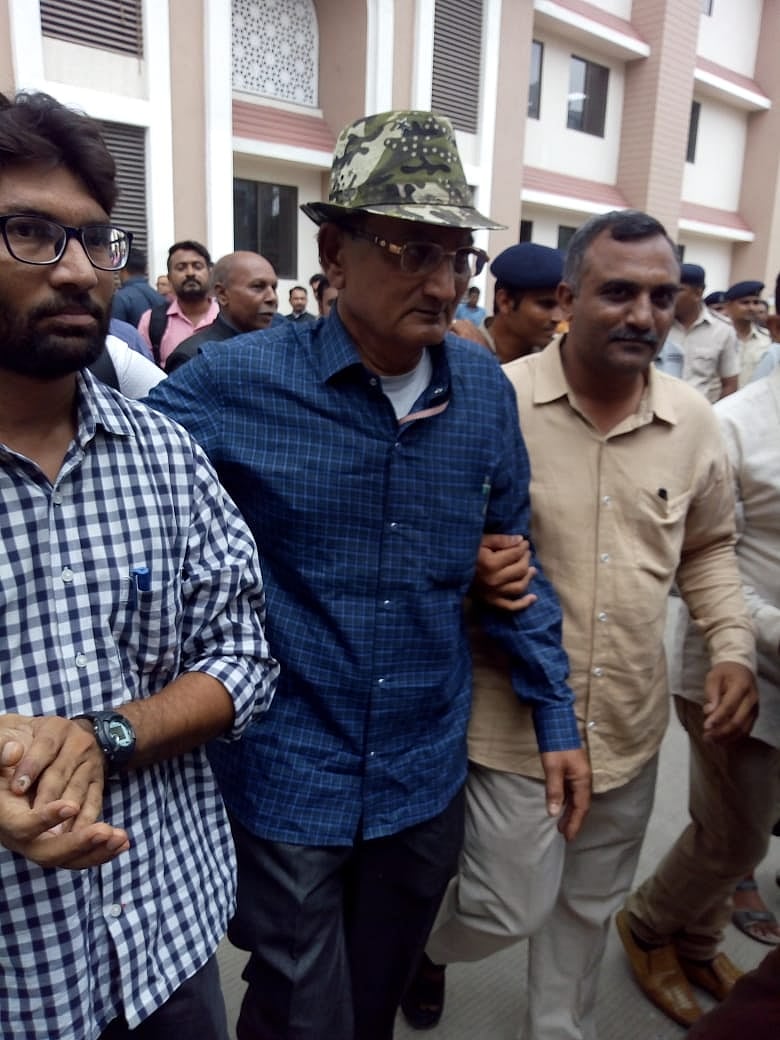 Bikhubhai ( in the middle middle), father of Amit Jethva, coming out of the court who is accompanied by independent MLA Jignesh Mevani.