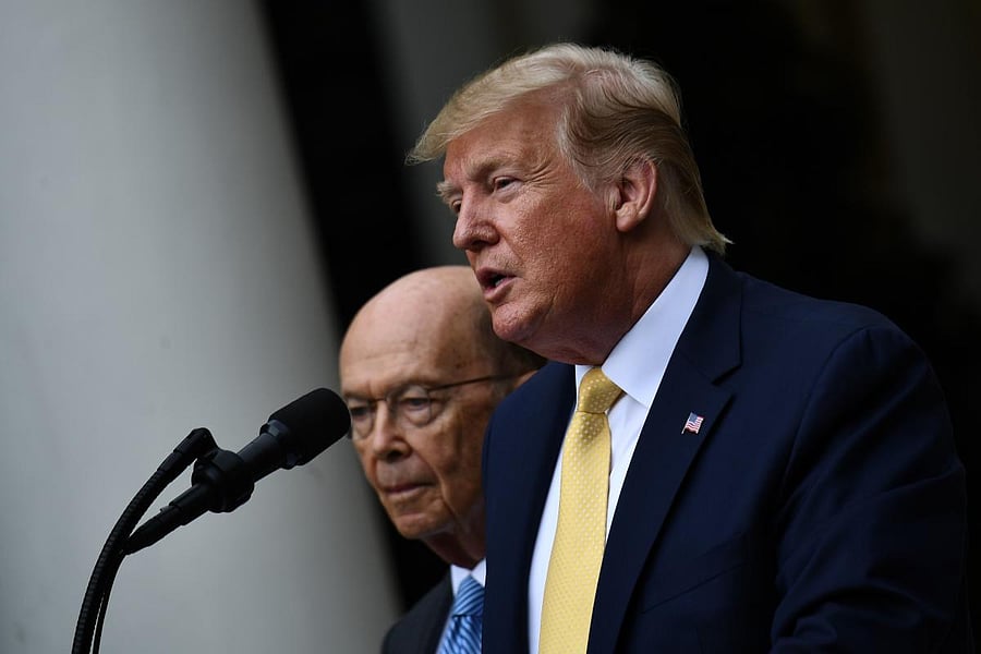 US President Donald Trump, flanked by US Secretary of Commerce Wilbur Ross, delivers remarks on citizenship and the census in the Rose Garden at the White House in Washington, DC, on July 11, 2019. (AFP)