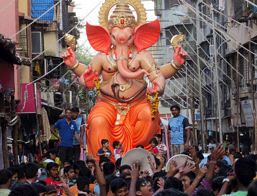 Devotees take a Ganesh idol to a pandal for the upcoming Ganesh Chaturthi festival in Thane, Mumbai on Saturday. PTI Photo