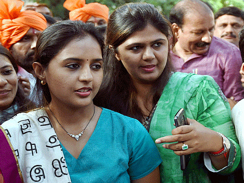 ers celebrate Mumbai : Newly elected BJP MP Pritam Munde and her sister Pankaja Munde celebrate their victroy at the party office in Mumbai on Monday. PTI Photo