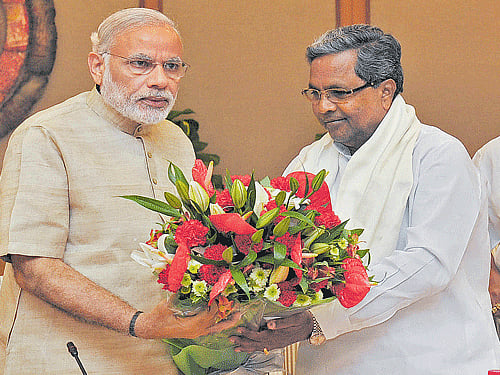 Chief Minister Siddaramaiah with Prime Minister Narendra Modi on Monday. DH Photo