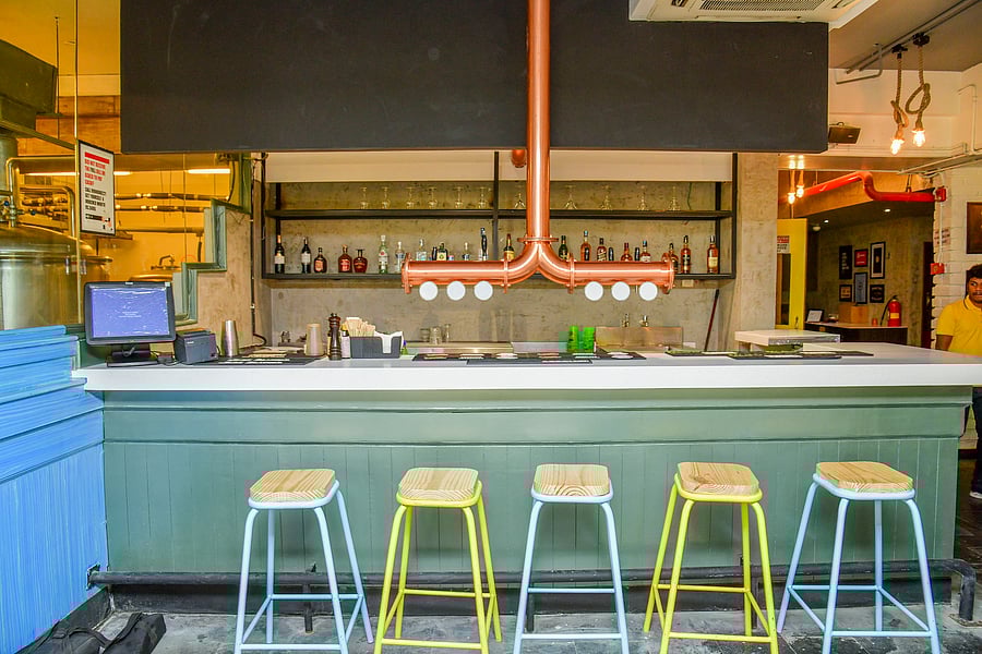 With bright colours and quirky lightings, the restaurant in Indiranagar has community tables that complement the space.
