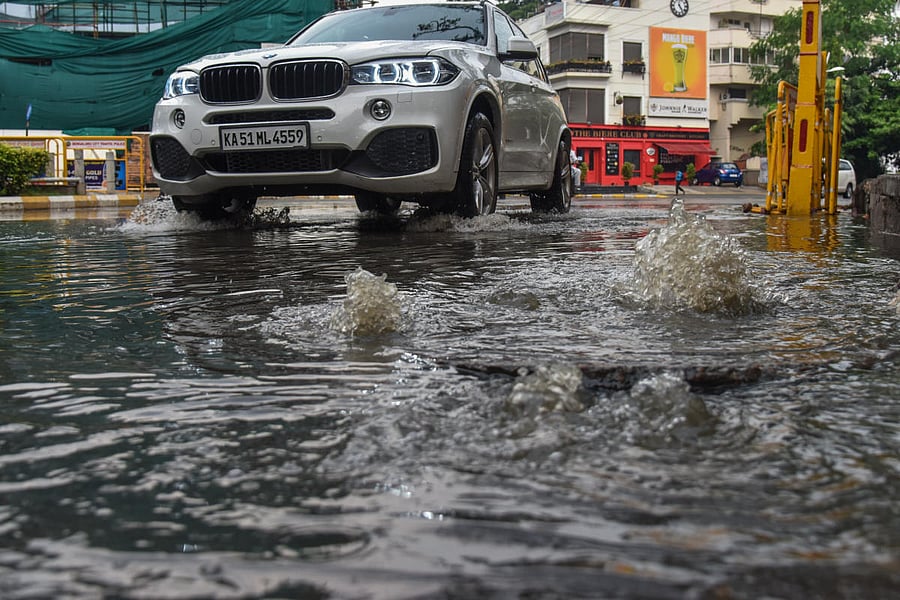 An overflowing manhole on Vittal Mallya Road. DH FILE PHOTO