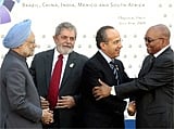 Prime Minister Manmohan Singh greets Presidents of other countries prior to a group photo of the G5 countries in L'Aquila, Italy on Wednesday. AP