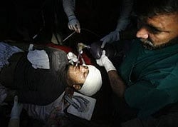 An anti-polio drive campaign worker, Hilal Khan, who was shot and badly injured by unidentified gunmen, receives treatment at Lady Reading Hospital in Peshawar December 19, 2012. Reuters