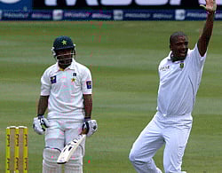 South Africa's Vernon Philander celebrates with teammate Dean Elgar (R) after taking the wicket of Pakistan's Asad Shafiq (L) during the second day of their first test cricket match in Johannesburg, February 2, 2013. REUTERS