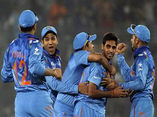 India's fielders congratulate teammate Bhuvneshwar Kumar after he dismissed Pakistan's Kamran Akmal successfully during their match of ICC Twenty20 World Cup at the Sher-E-Bangla National Cricket Stadium in Dhaka. Reuters Photo