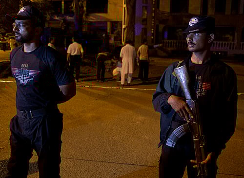 Pakistani investigators examine a site of a bomb blast in Islamabad, Pakistan, Saturday morning, May 24, 2014. A suspected suicide bomber blew himself up in the parking lot of a market in the capital, police said. AP