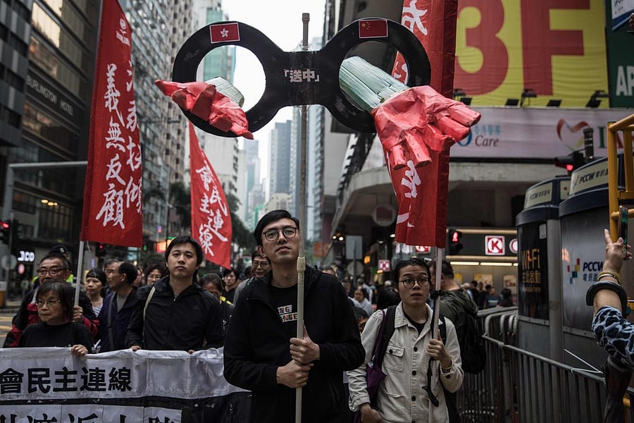Protesters march along a street during a rally in Hong Kong on March 31, 2019, to protest against the government's plans to approve extraditions with mainland China, Taiwan and Macau. (AFP Photo)