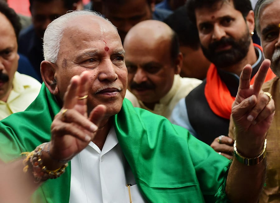 BJP leader B S Yeddyurappa flashes the victory sign before taking oath as Karnataka Chief Minister, at Raj Bhavan in Bengaluru, Friday, July 26, 2019. (PTI Photo/Shailendra Bhojak)