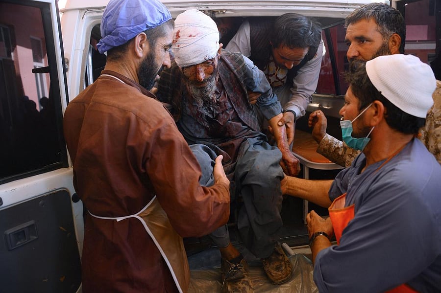 A wounded Afghan man is brought to a hospital after roadside bomb hit a passenger bus, in Herat (AFP PHOTO / HOSHANG HASHIMI)