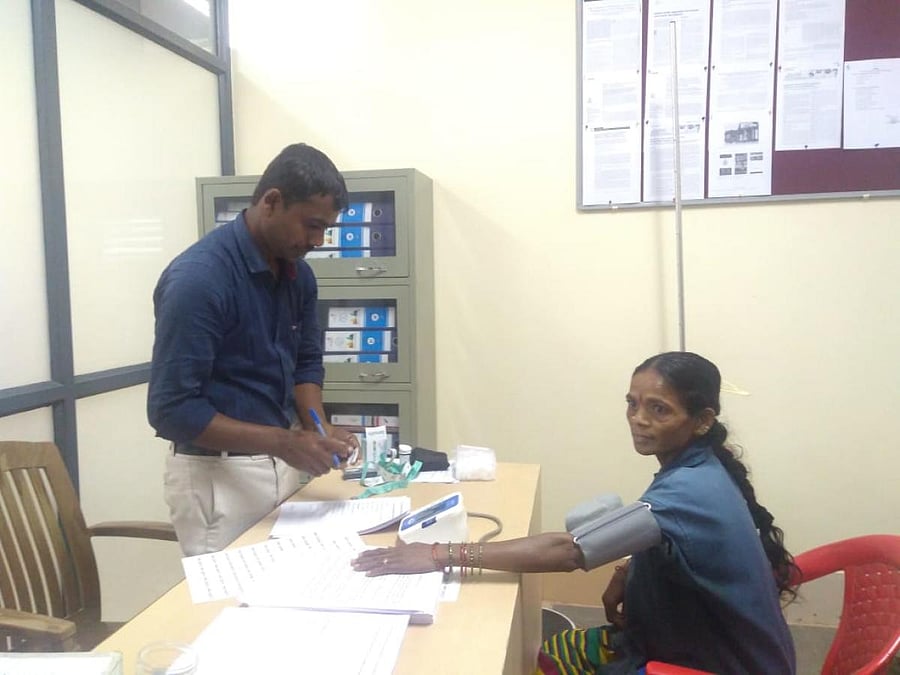 A pourakarmika undergoing screening by Biocon doctors.