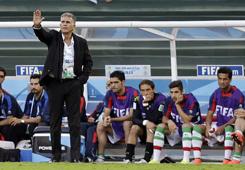 ran's head coach Carlos Queiroz gestures from the touchline during the group F World Cup soccer match between Iran and Nigeria at the Arena da Baixada in Curitiba. AP photo