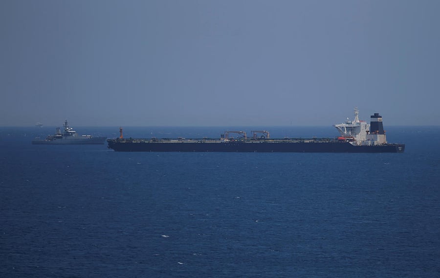 A British Royal Navy patrol vessel guards the oil supertanker Grace 1, that's on suspicion of carrying Iranian crude oil to Syria. (Reuters Photo)