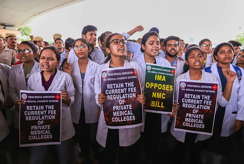 Doctors and medical students of AIIMS display placards during a strike to protest the introduction of the National Medical Commission (NMC) Bill in the Rajya Sabha, in New Delhi. (PTI Photo)