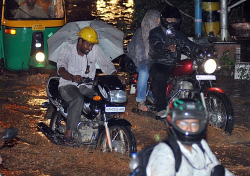 Heavy rains lashed the metropolis on Wednesday, severely disrupting road, rail and suburban train services and caused inconvenience to lakhs of commuters and office goers. DH file photo for representation only