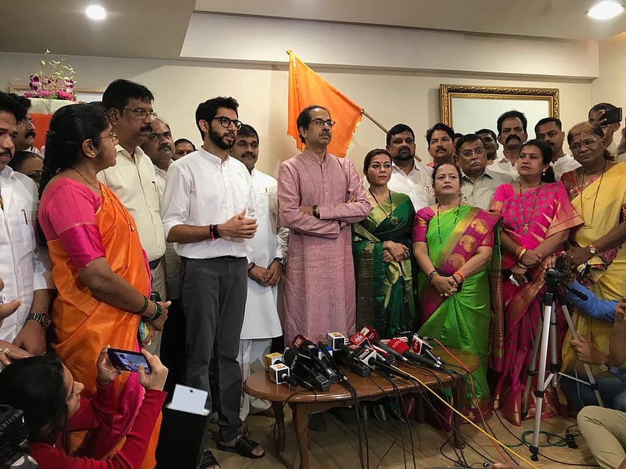 Sachin Ahir stands between Shiv Sena chief Uddhav Thackeray and Yuva Sena president Aditya Thackeray at Matoshree in Mumbai.