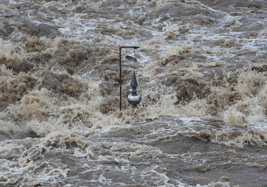 A temple is seen submerged in the waters of overflowing river Godavari after heavy rainfall in Nashik. Reuters