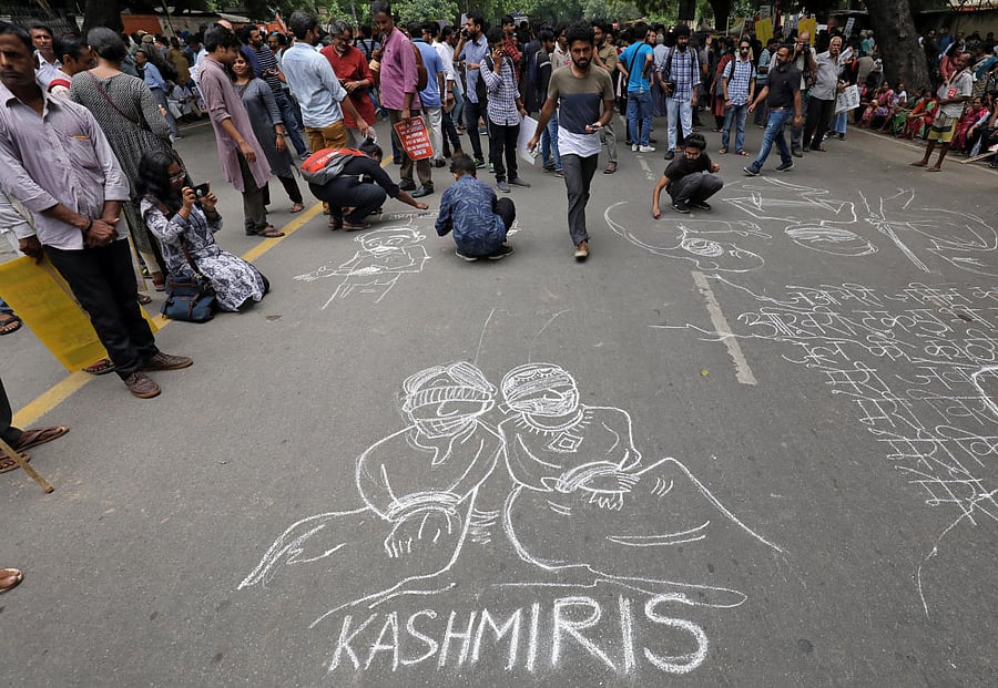 People draw and write messages on a road during a protest against the scrapping of the special constitutional status for Kashmir by the government, in New Delhi, India, August 7, 2019. REUTERS/Anushree Fadnavis