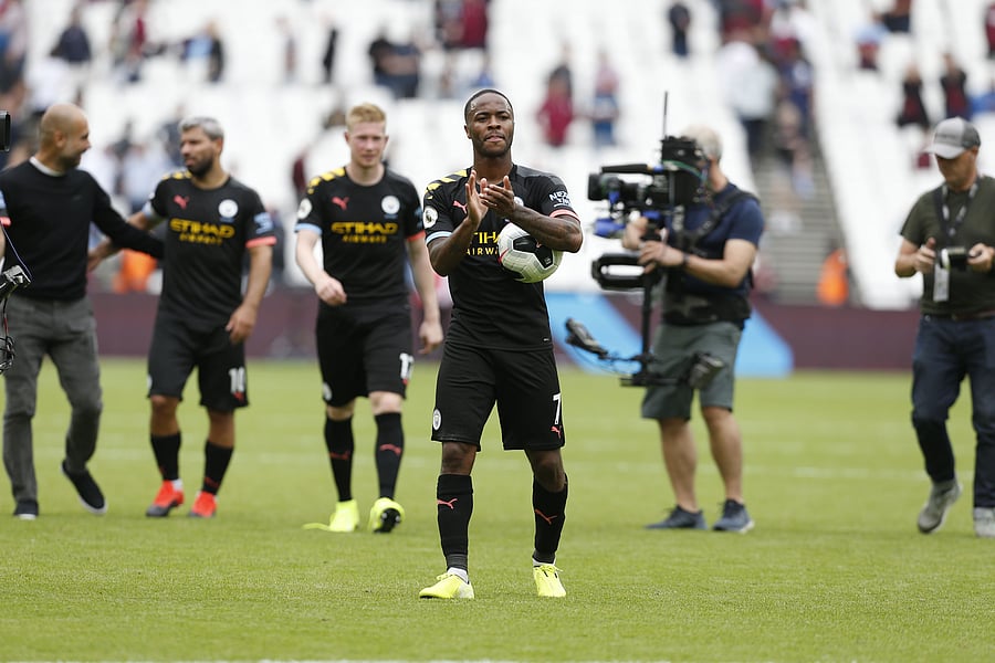 Manchester City's English midfielder Raheem Sterling applauds as he carries the match ball after scoring a hatttick to help his team win 5-0 during the English Premier League football match between West Ham United and Manchester City. (AFP Photo)