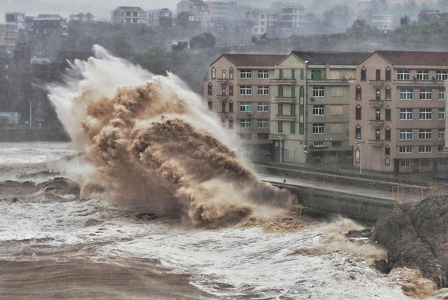 Waves hit a sea wall in front of buildings in Taizhou, China's eastern Zhejiang province. (AFP Photo)