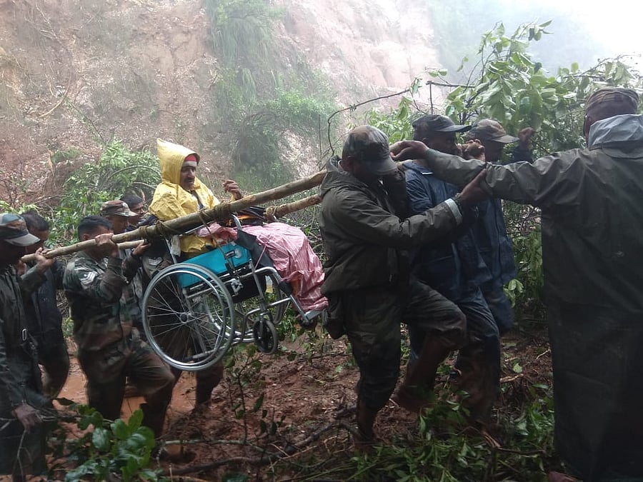 Troops from the Madras Engineers Group evacuate Narayan Gowda, a 48-year-old resident from Alehkhan, who was trapped under a tree for 36 hours in Chikkamagaluru District on 11 August 2019.