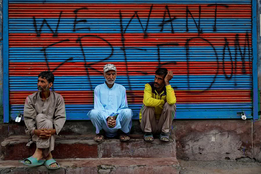 Kashmiri men wait before Eid-al-Adha prayers during restrictions after the scrapping of the special constitutional status for Kashmir by the Indian government, in Srinagar, August 12, 2019. REUTERS/Danish Siddiqui