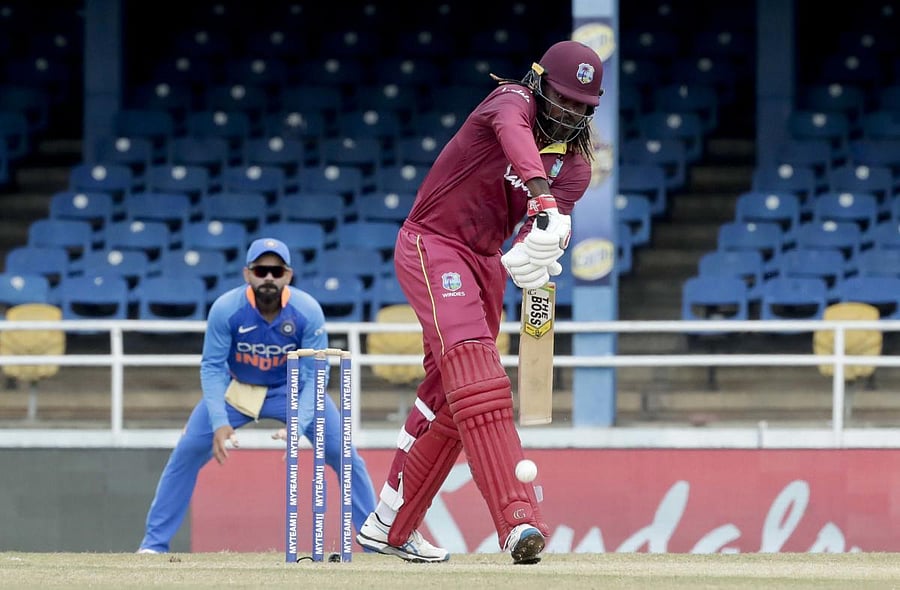 West Indies opening batsman Chris Gayle defends his wicket on the third One-Day International cricket match against India in Port of Spain. (PTI Photo)