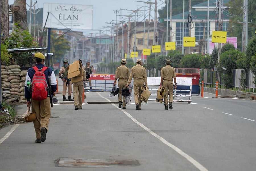 Policemen patrol on a deserted road during a lockdown in Srinagar on August 15, 2019, as India celebrates its 73rd Independence Day. (Photo AFP)