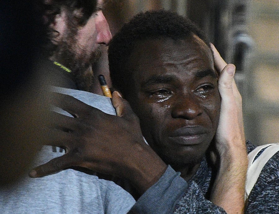 A migrant reacts as he disembarks the Spanish rescue ship Open Arms NGO, after it arrived in Lampedusa, Italy. Reuters photo