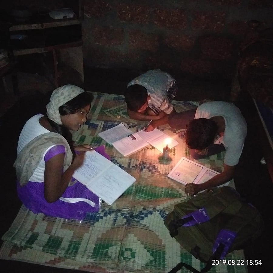 Children study using a kerosene lamp, at a house in Thathkola in Chikkamagaluru district.