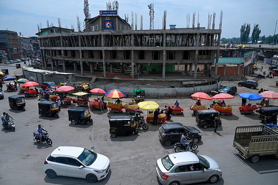 Residents drive along a busy road in Srinagar. (AFP Photo)