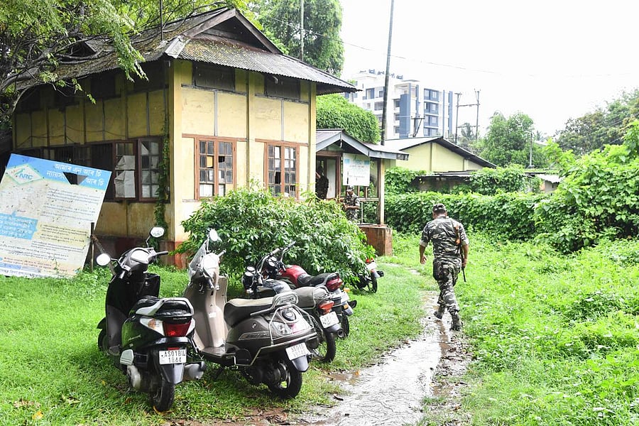 Security personnel walk near a National Register of Citizens (NRC) office ahead of the release of the register's final draft in Guwahati, the capital city of Assam. AFP