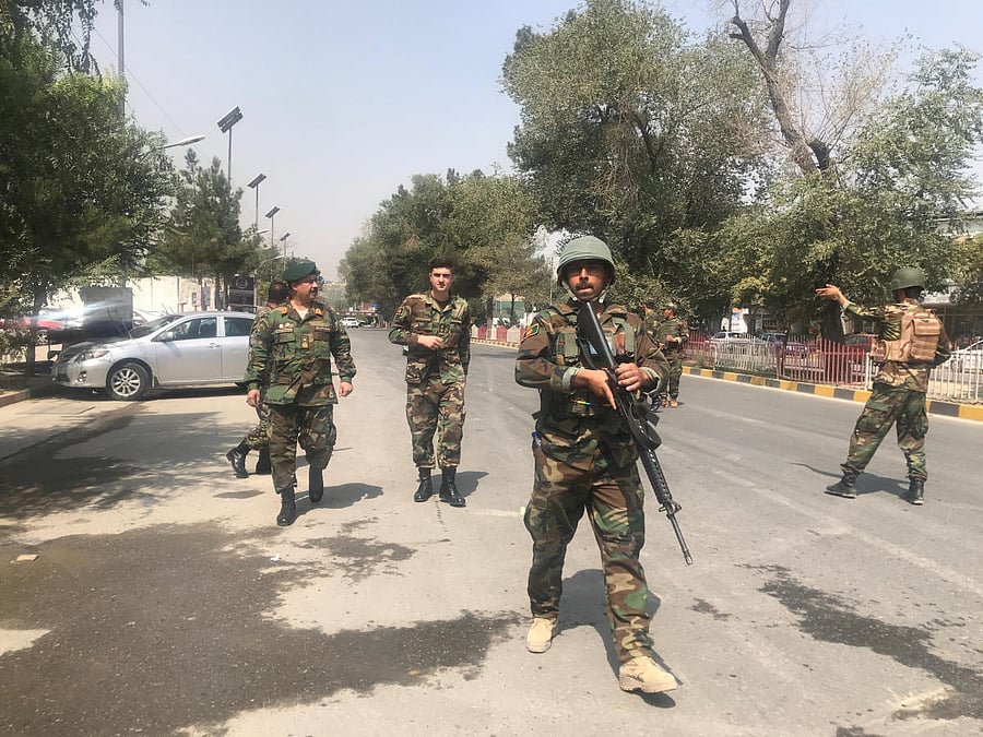 Security forces are seen near the site where suicide bomber blew himself up in the centre of Kabul, Afghanistan. (Reuters Photo)