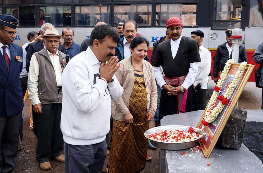 Dignitaries pay floral tributes to the portrait of Squadron Leader Ajjamada Devaiah, near the private bus stand in Madikeri on Saturday.