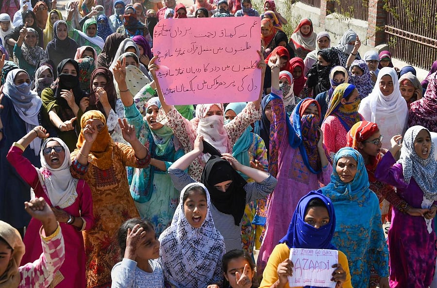 Women hold placards and raise slogans during a peaceful protest march against abrogation of Article 370 and bifurcation of the state into two union territories, in Srinagar on Friday. (PTI Photo)