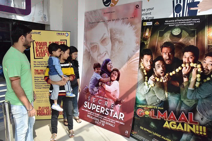 Moviegoers at the Inox in Lido mall looking at the flexes of commercial releases.