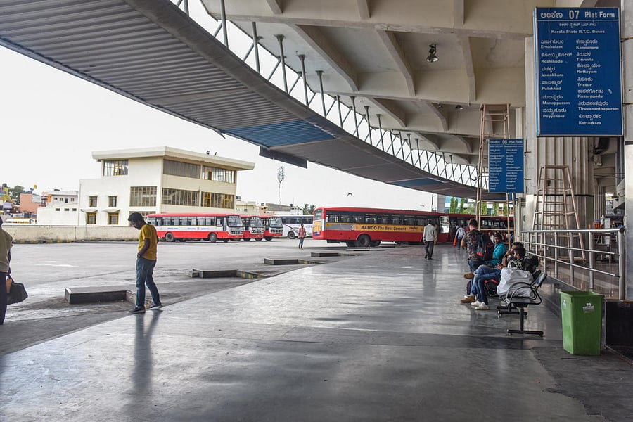 Passengers are waiting for Kerala state buses to reach their destinations, at Satellite Bus stand, Mysuru road in Bengaluru on Monday, due to Kerala Inter State Bus Owners Association call Inter State Buses form Kerala stops operation protest against Moto