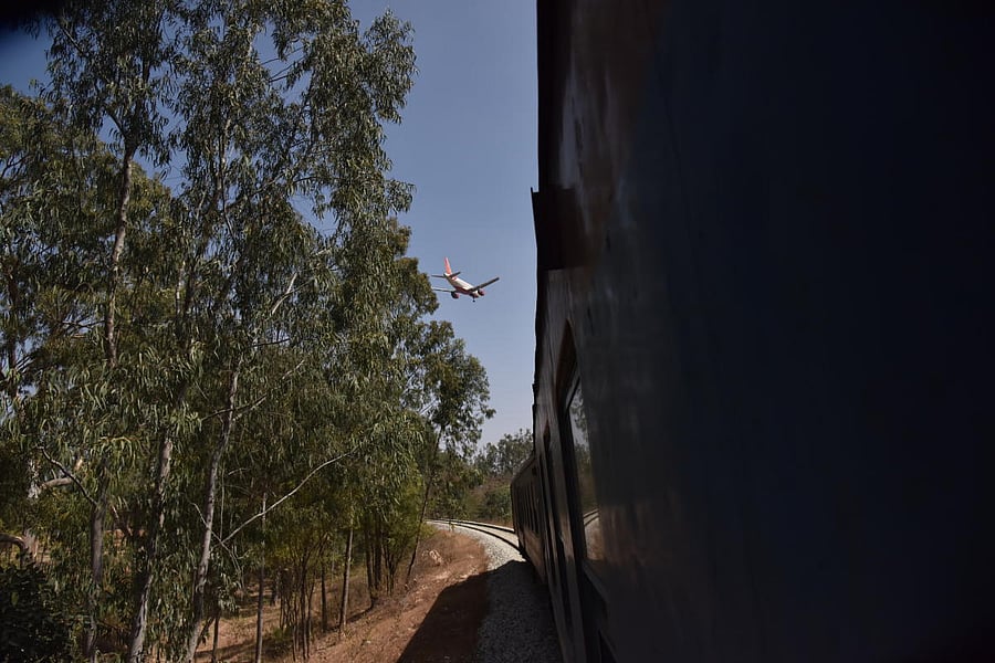 A DEMU train passes close to the airport periphery near the spot where a halt station is to come up. DH File/Shivakumar B H